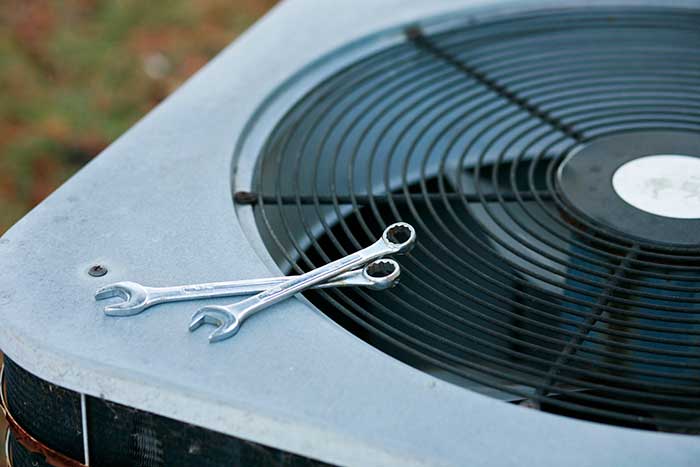 AC Unit with wrenches